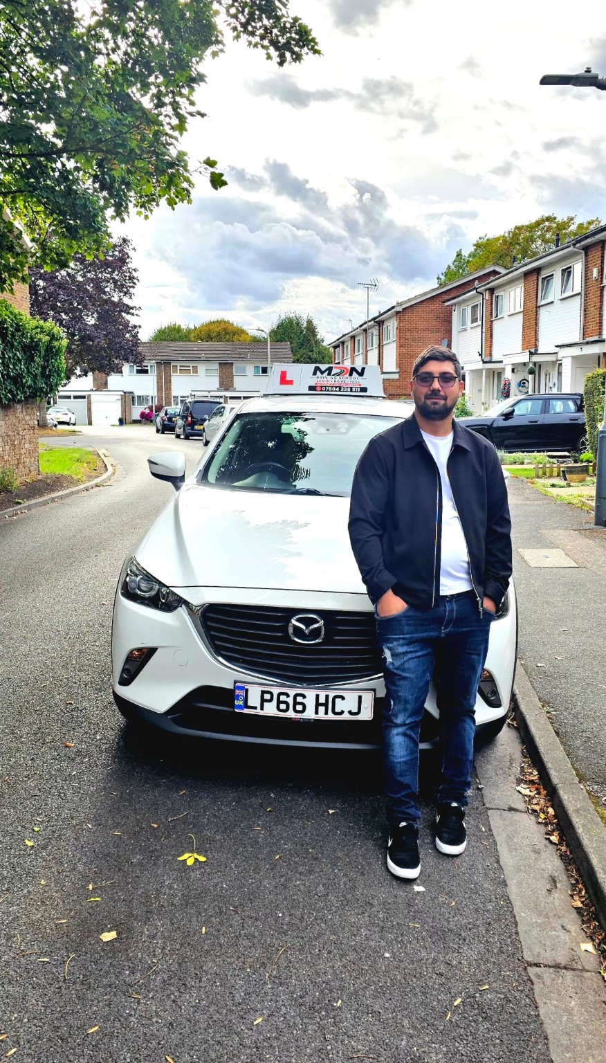 Mihai, DVSA-approved driving instructor, with the MDN Driving School car